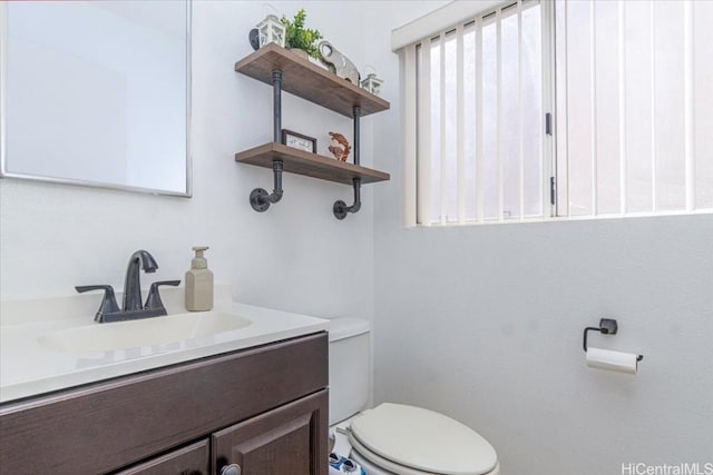 bathroom featuring toilet and vanity