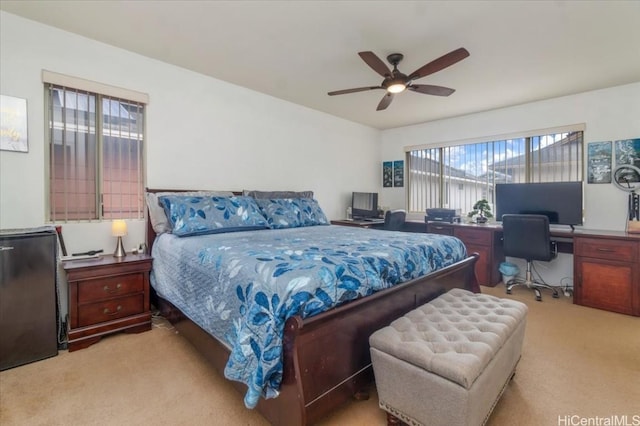 bedroom with ceiling fan and light carpet