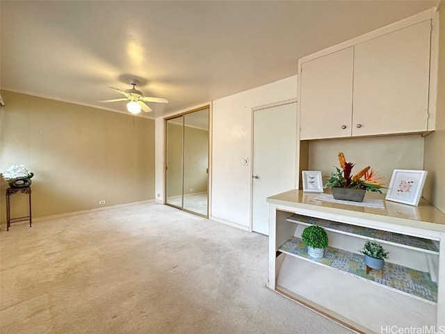 interior space with ceiling fan