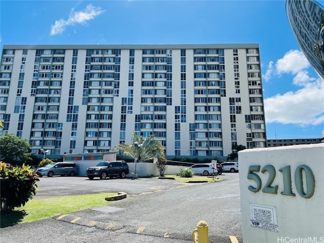 view of building exterior with uncovered parking