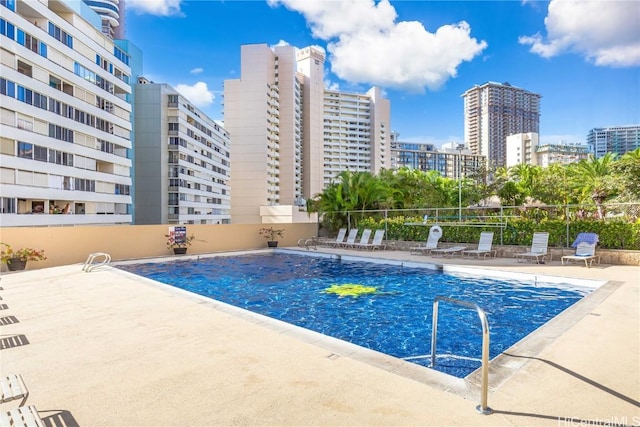 view of swimming pool with a patio