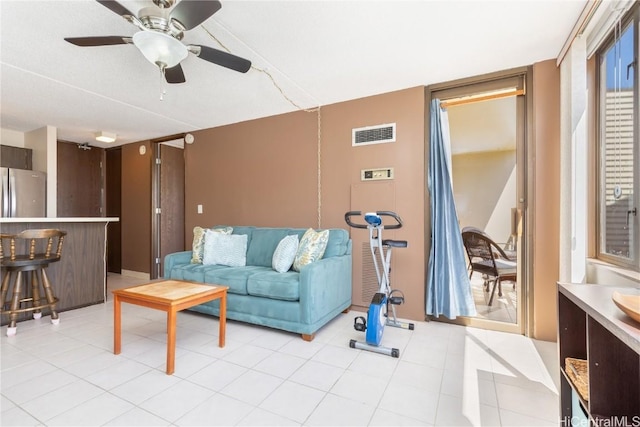 living room with ceiling fan and bar area