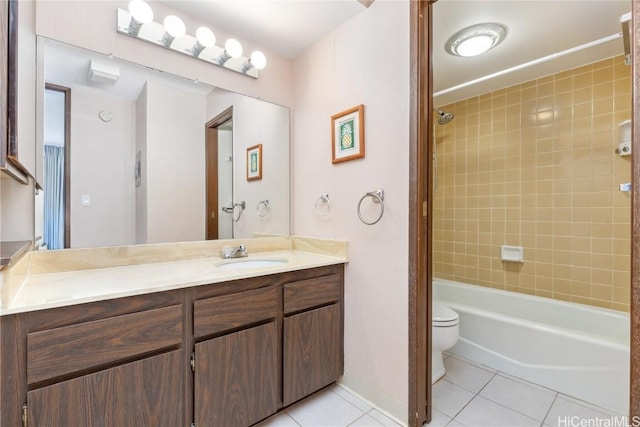 full bathroom with tile patterned floors, toilet, vanity, and tiled shower / bath