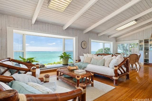 sunroom with a water view, vaulted ceiling with beams, and wooden ceiling