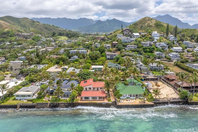 birds eye view of property with a water and mountain view