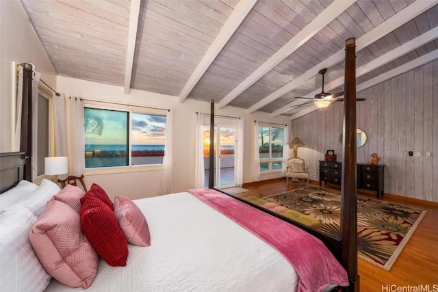 bedroom with wood ceiling, hardwood / wood-style floors, wooden walls, ceiling fan, and lofted ceiling with beams