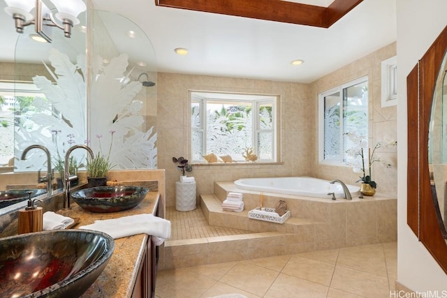 bathroom featuring tiled tub, tile patterned floors, and vanity