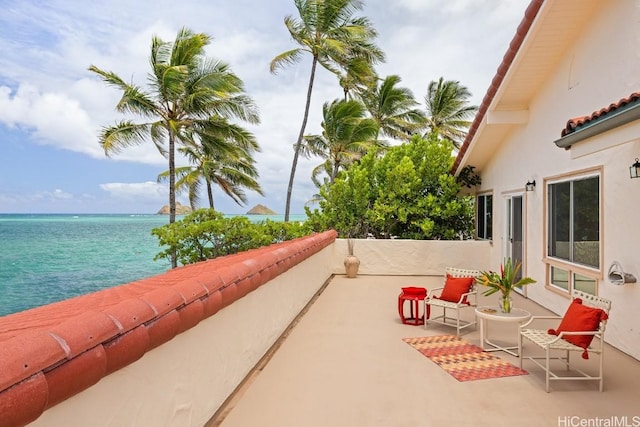 view of patio with a water view