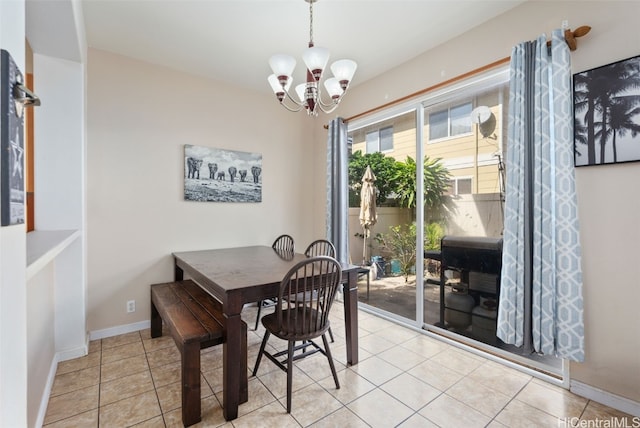 tiled dining space featuring a notable chandelier