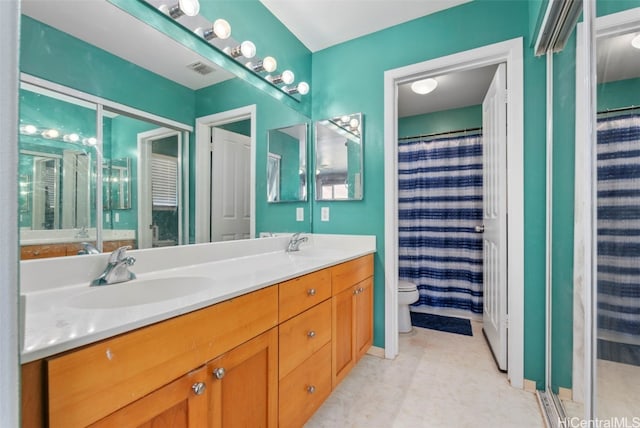 bathroom featuring toilet, a shower with shower curtain, and vanity