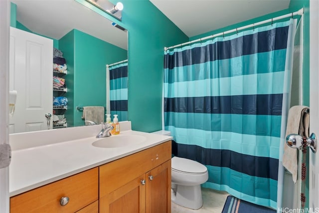 bathroom featuring toilet, walk in shower, and vanity