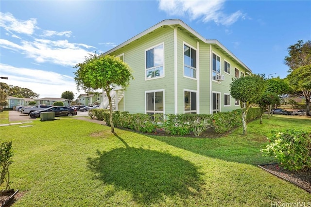 view of side of home featuring a lawn