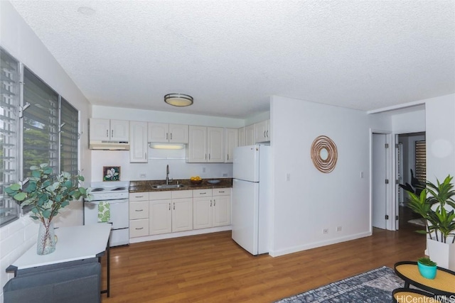 kitchen featuring a textured ceiling, white cabinetry, dark hardwood / wood-style flooring, and white appliances