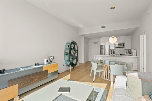 living room featuring visible vents and light wood finished floors