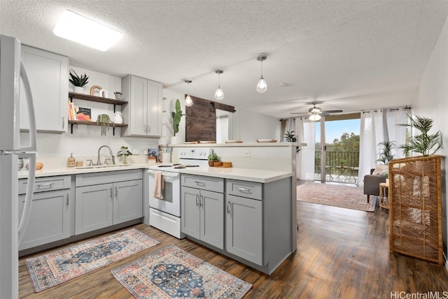 kitchen featuring sink, white appliances, gray cabinets, hanging light fixtures, and kitchen peninsula