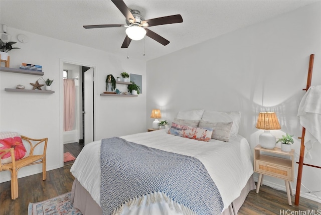 bedroom with dark hardwood / wood-style floors and ceiling fan