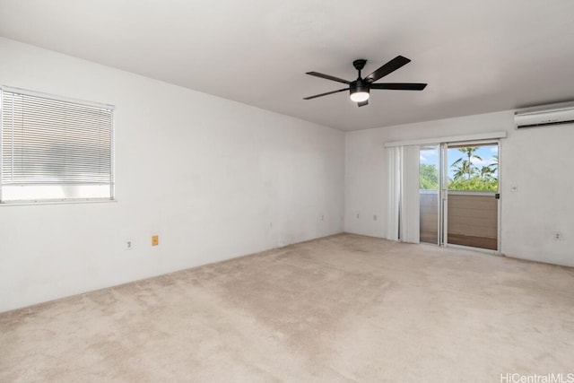 carpeted spare room featuring ceiling fan and a wall mounted air conditioner