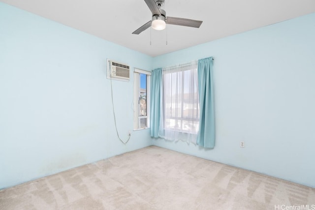 spare room with an AC wall unit, light carpet, and ceiling fan