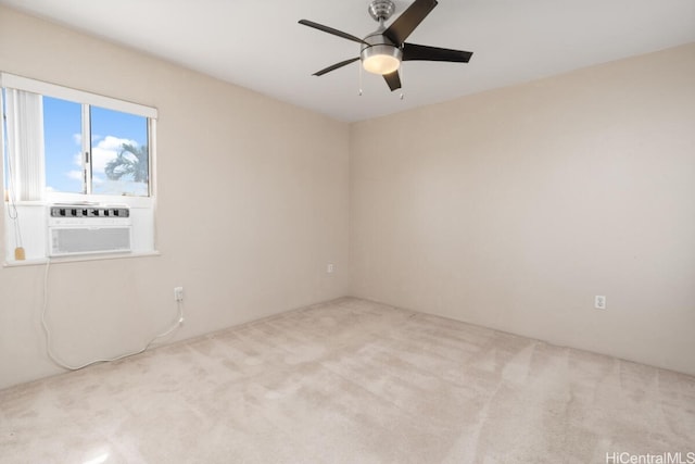 empty room featuring ceiling fan, light colored carpet, and cooling unit