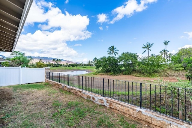 view of yard featuring a water and mountain view