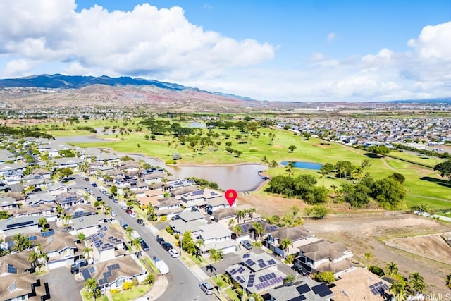 birds eye view of property with a water and mountain view