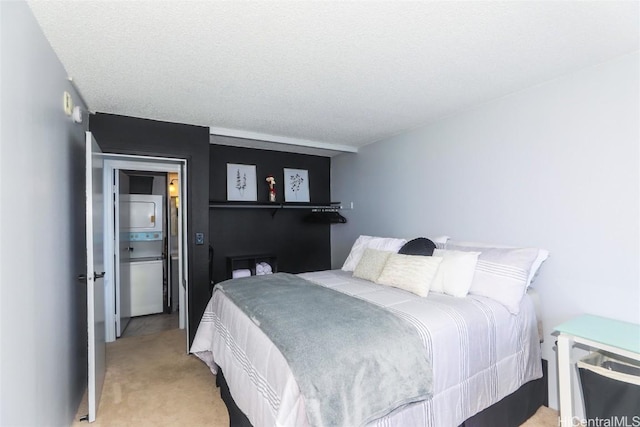 bedroom with stacked washing maching and dryer, light carpet, and a textured ceiling