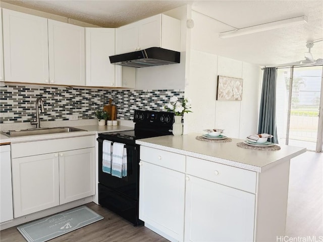 kitchen with white cabinetry, black electric range oven, sink, and backsplash