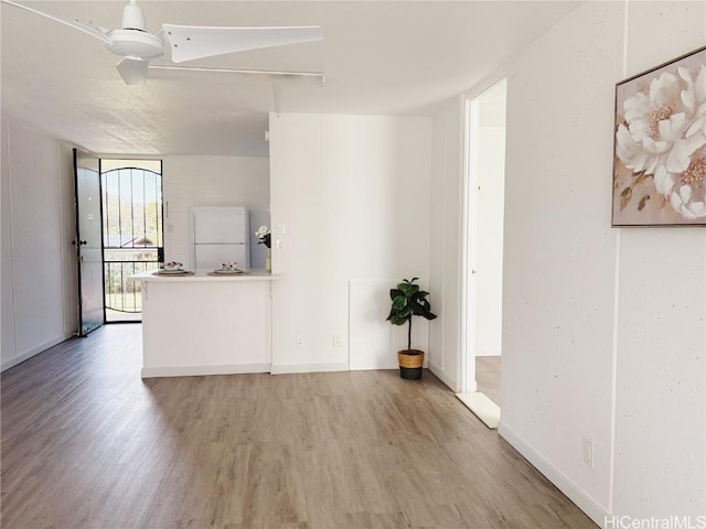 interior space with a wall of windows and hardwood / wood-style floors