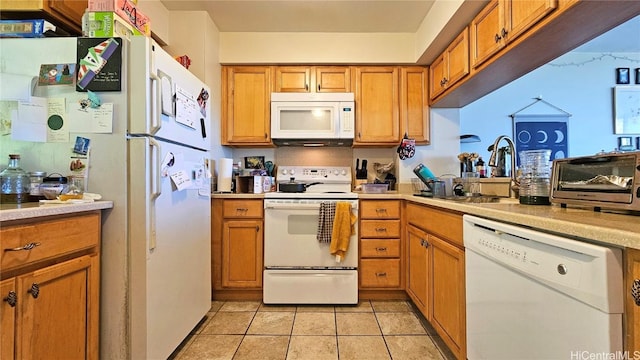 kitchen featuring light tile patterned floors, sink, and white appliances