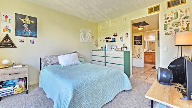 tiled bedroom featuring ensuite bath