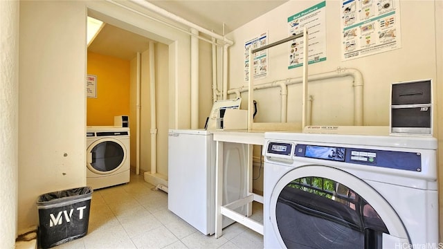 clothes washing area featuring washing machine and clothes dryer