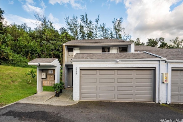 view of front of house with a garage and a front yard