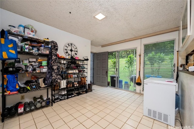 interior space featuring fridge and a textured ceiling