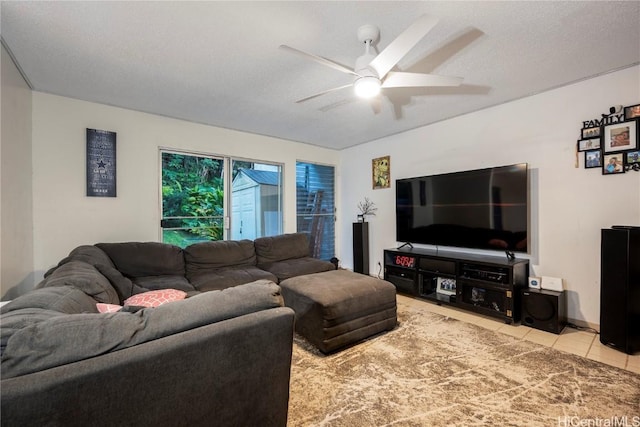 living room featuring a textured ceiling, ceiling fan, and tile patterned floors