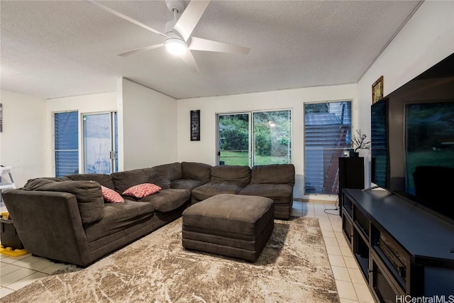 tiled living room with ceiling fan and a textured ceiling