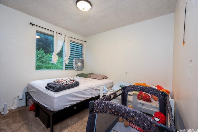 bedroom with a textured ceiling and carpet flooring