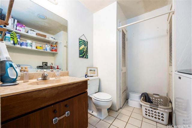 bathroom featuring toilet, tile patterned flooring, and vanity