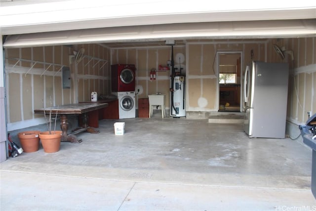 garage with sink, stacked washer / dryer, water heater, and stainless steel refrigerator