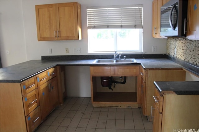 kitchen featuring kitchen peninsula, tile patterned floors, and sink