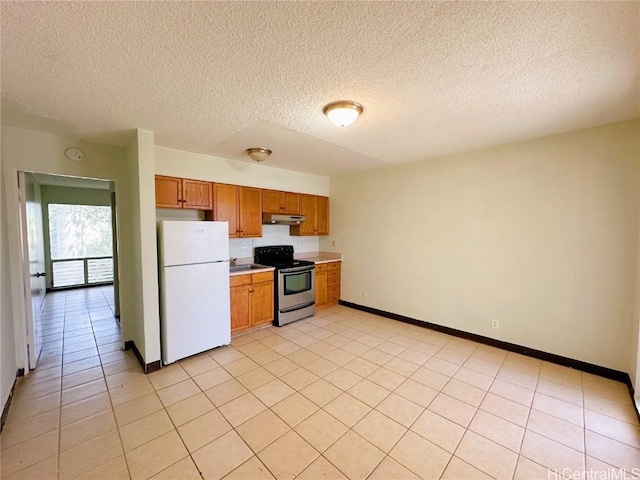 kitchen with light tile patterned floors, stainless steel range with electric cooktop, white refrigerator, and a textured ceiling