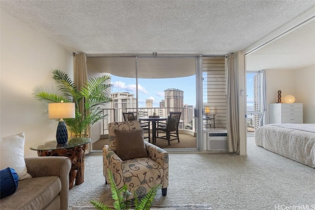 bedroom with access to exterior, carpet flooring, floor to ceiling windows, and a textured ceiling