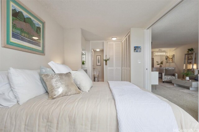 bedroom featuring carpet floors and connected bathroom