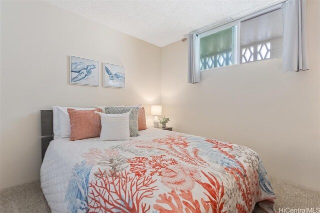 bedroom featuring a textured ceiling and carpet flooring