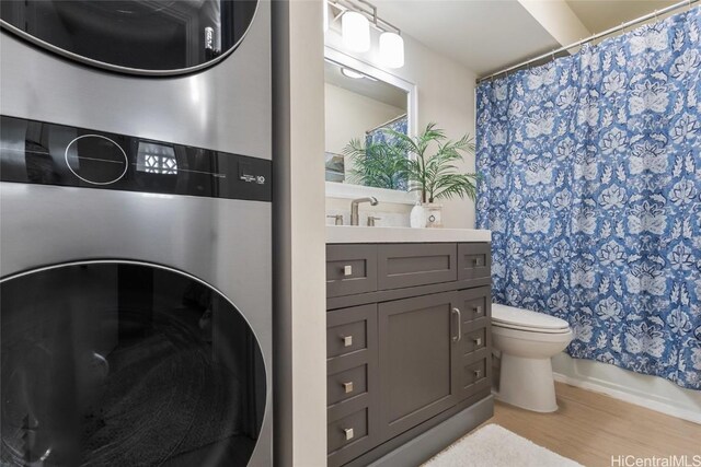 bathroom featuring hardwood / wood-style floors, toilet, vanity, and a shower with curtain