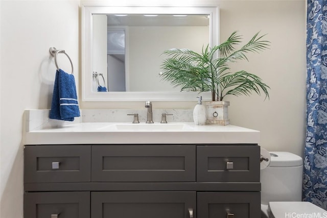 bathroom featuring toilet and vanity