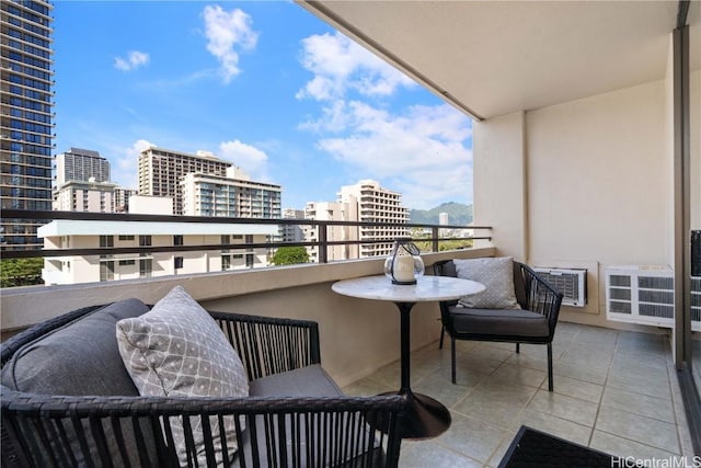 balcony featuring an AC wall unit