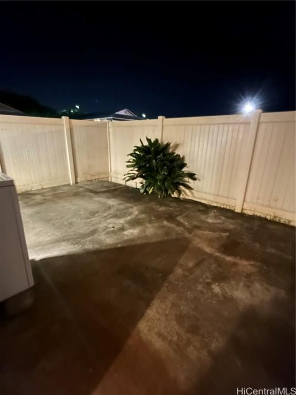 yard at night featuring a patio