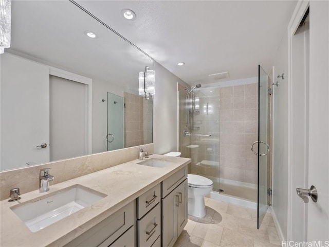 bathroom with toilet, tile patterned flooring, a shower with shower door, and vanity