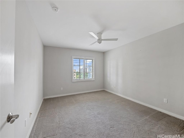 spare room with ceiling fan and carpet