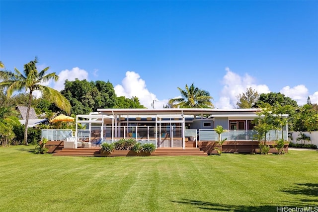 back of house featuring a wooden deck and a lawn